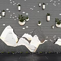 Courtyard Garden With Gray Wall White Dot Decorations White Planters Green Plants And Rock Formations