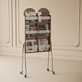 Wooden Storage Shelf with Silver Metal Legs and Wheels Holding Books on Decorative Wall Background