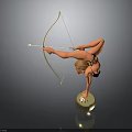 Graceful Woman Doing Handstand On Golden Ball While Holding Bow