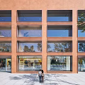 Red Brick Multi Storey Office Building With Glass Windows Along City Street