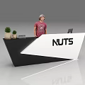Exhibition Reception Desk with NUTS Logo Black White Design Small Plants and Staff Reception