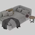 Modern Two Seater Sofa With Striped Pillows Knitted Blanket And Side Table