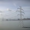 Road Facilities With Tall Transmission Towers Overhead Wires And Cloudy Sky