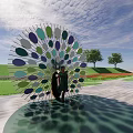 Vibrant Circular Landscape Sculpture With Colorful Green Purple Blue Leaves In Grass Field And Trees