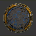 Worn Round Mechanical Object With Blue Top Yellow Base And Side Labels
