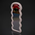 Decorative Mirror With Wavy White Frame Reflecting Red Flowers And Wooden Table Top