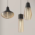 Three Modern Stylish Pendant Lights With Black Frames And Transparent Striped Shades