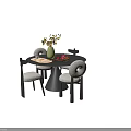 Round Dark Dining Table Set With Four Light Upholstered Chairs Green Vase And Yellow Flowers