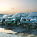Green Blue And Black Cars Including SUV Models Parked In Outdoor Parking Lot With Sunlight