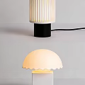 Modern Table Lamps Featuring Striped And Scalloped Shades With Black White Bases Illuminated