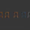 Five Different Colored Wooden Stools In Orange Light Brown Blue And White
