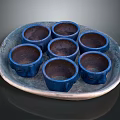 Set Of Six Glazed Blue Ceramic Cups On Decorative Textured Tray For Home Use