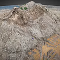 Large Dirt Mound With Gravel And Sparse Vegetation On Barren Ground With Tire Tracks