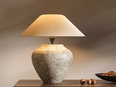 Textured Stone Table Lamp With Beige Lampshade On Wooden Table Near Nuts And Black Bowl 3d model