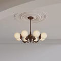 Elegant Brass Chandelier With Round Globe Lights On Decorative Ceiling Molding