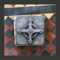 Intricately Carved Stone Pillar with Floral Patterns Ornate Top on Red Black Checkered Base