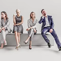 Group of Business Professionals Sitting on Sofa in Formal Attire