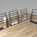 Black Metal Display Racks with Folded Fabrics and Box in Modern Design on Wooden Floor