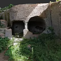 Natural Garden Landscape With Rocky Caves Stone Steps And Lush Green Vegetation