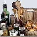 Kitchen Utensils Display On Wooden Tray With Jars Bread Basket And Spoons