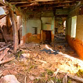 Dilapidated Building Interior With Collapsed Wooden Beams Broken Walls And Peeling Paint