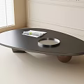 Modern Black Oval Coffee Table with Metal and Wooden Legs and Silver Tray plus Magazine
