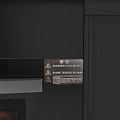 Sleek Black Integrated Kitchen Stove With Copper Pots And Oven Roasting Chicken On Gray Countertop