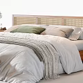 Modern Minimalist Double Bed with Rattan Headboard Bedside Tables Decorative Vases Soft Quilt and Pillows