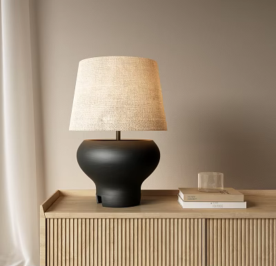 Table Lamp With Beige Linen Shade And Black Round Base On Wooden Cabinet With Books 3d model