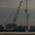 Heavy Duty Utility Vehicle Crane Operating At Urban Construction Site With Tower Structure