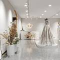 Elegant Bridal Shop with Grey Lace Wedding Dress on Display Platform and Hanging Bridal Gowns