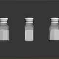 Glass Spice Bottles With Silver Lids Containing Various Seasonings For Kitchen