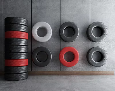 Stacked Black Tires with Red Stripes and Colorful Rims Arranged Against Gray Concrete Wall 3d model
