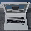 White Dell Laptop Open With Screen Display And Pink Laptop Case On Wooden Floor