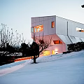 Modern Geometric Detached House With White Exterior Large Windows In Snowy Winter