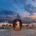 Waterfront Wedding Setup With Flower Arch Wooden Walkway And Yachts At Sunset