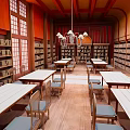Traditional Library Interior Featuring Wooden Bookshelves Long Tables Chairs And Chandelier