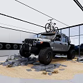 Car Showroom Showcasing Jeep Rubicon With Bicycle On Roof Rocks And Sand In Glass Walls