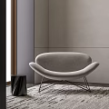 Modern Gray Accent Chair with Curved Backrest Metal Legs and Side Table in Minimalist Room