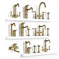 Various Styles of Golden Faucets Neatly Displayed on White Shelves