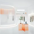 Modern Clothing Store Interior Featuring White Walls Orange Accents Clothing Racks Plants And Display Tables