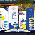 Outdoor Book Themed Installation With People Reading Stacked Books And Open