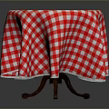 Round Dining Table With Red And White Checkered Tablecloth And Wooden Legs