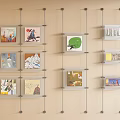 Abstract Paintings Display On Wall With Glass Shelves Neutral Beige Background And Artworks