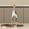 Elegant Transparent Wine Bottle with Gold Cap and Glasses on Gold Tray Over Light Countertop with Wall Panels