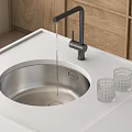 Stainless Steel Kitchen Sink With Black Faucet Running Water White Countertop Wooden Cabinets Glass Cups