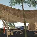 Bamboo Homestay Building With Thatched Roof Surrounded by Trees and Natural Environment