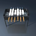 Grill With Skewers And Ice Cubes On Black Metal Frame With Wooden Handles