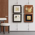 Abstract Paintings Displayed On Wall With Four Wooden Frames And White Stool