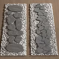 Rockery Stones Arranged With Pebbles On Wooden Floor In Two Sections